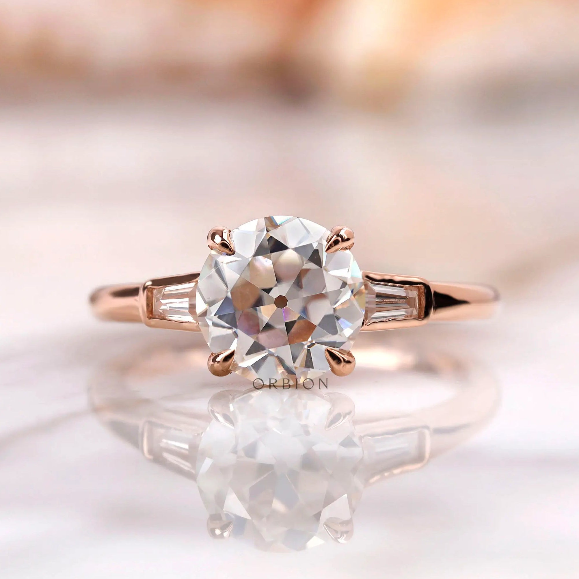 Front view of round Old European Cut moissanite ring with baguette side stones