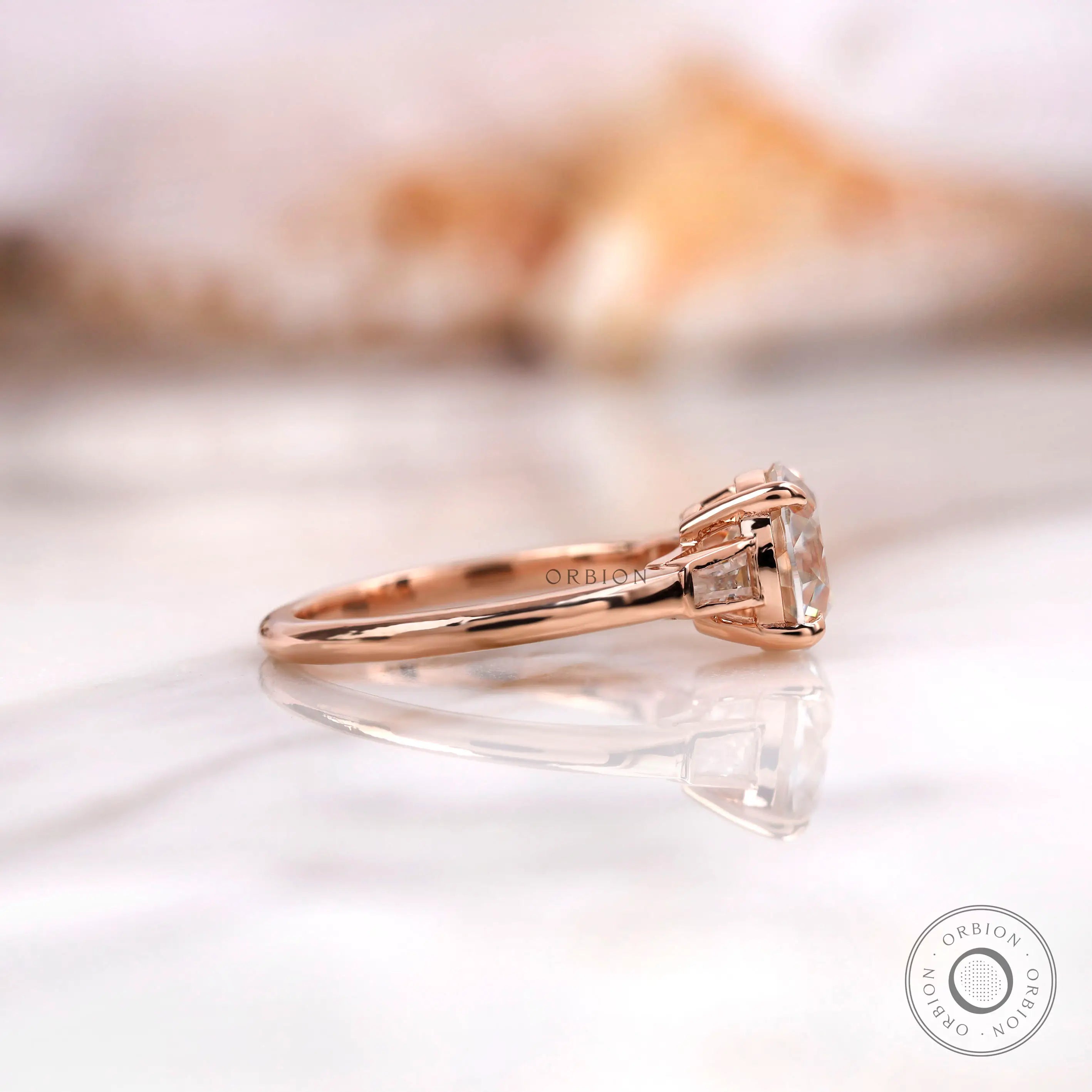 Side profile of Old European Cut moissanite three stone ring in 10K rose gold