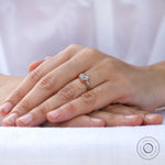 Round Old European Cut moissanite three stone ring in rose gold on hand view