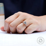 On-hand view of cathedral style moissanite three stone engagement ring