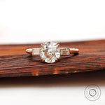 Moissanite three-stone round Old European cut ring with baguette side stones in 10K yellow gold