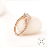 Profile of Moissanite three-stone ring with round Old European cut center stone and baguette side stones in 10K yellow gold