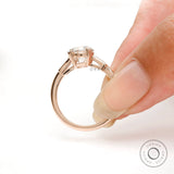 Back view of Moissanite three-stone ring with round Old European cut center and baguette side stones