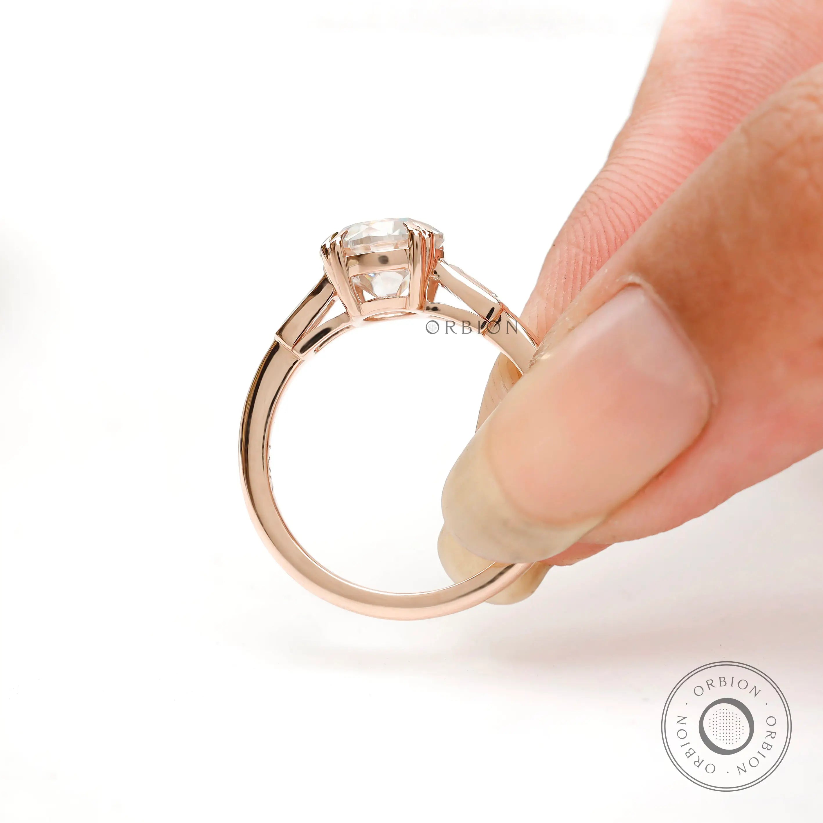 Back view of Moissanite three-stone ring with round Old European cut center and baguette side stones