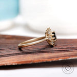 Side profile of black moissanite halo ring in 10K yellow gold