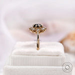 Elevated side view black moissanite halo ring on display