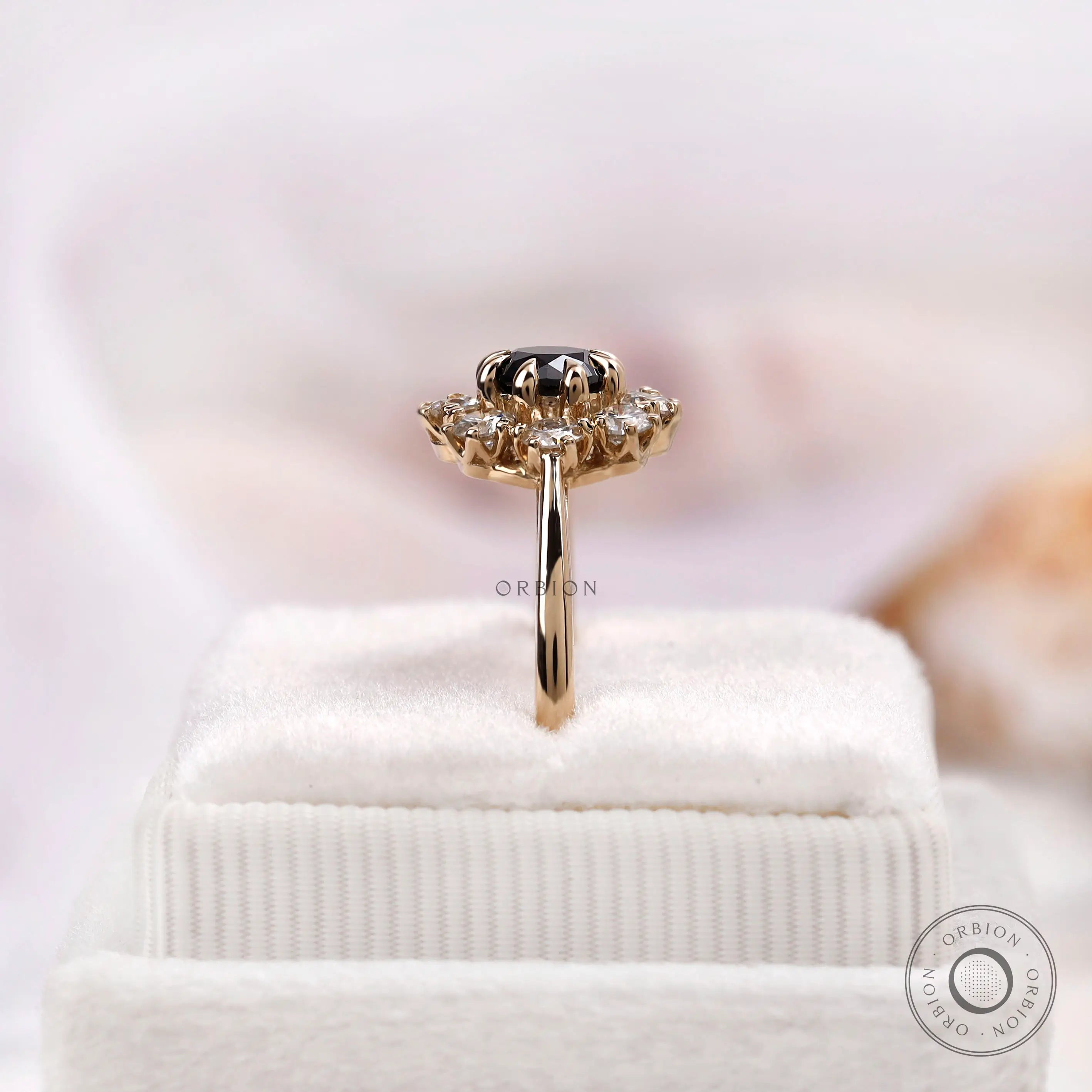 Elevated side view black moissanite halo ring on display