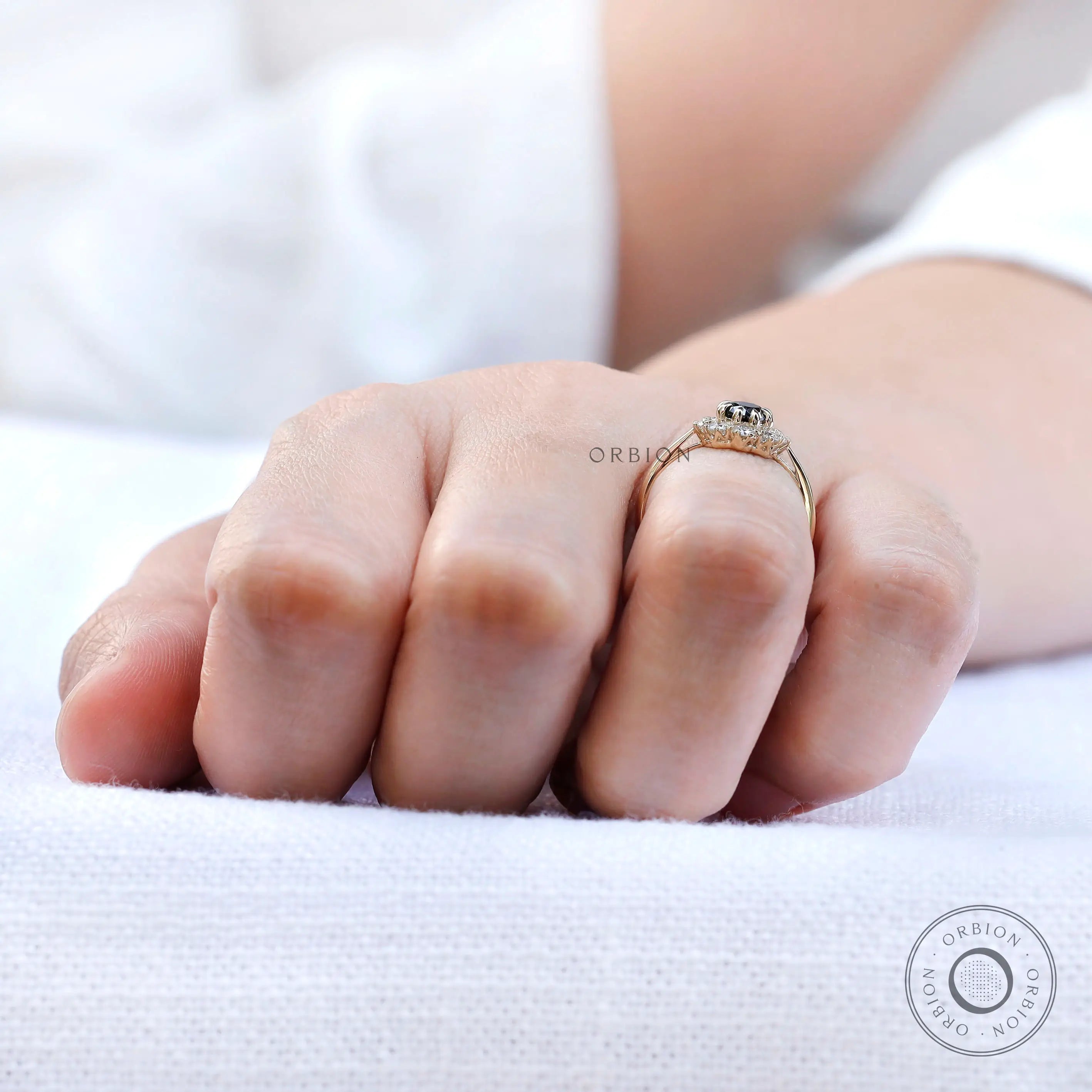 On-hand side view showing black moissanite halo profile