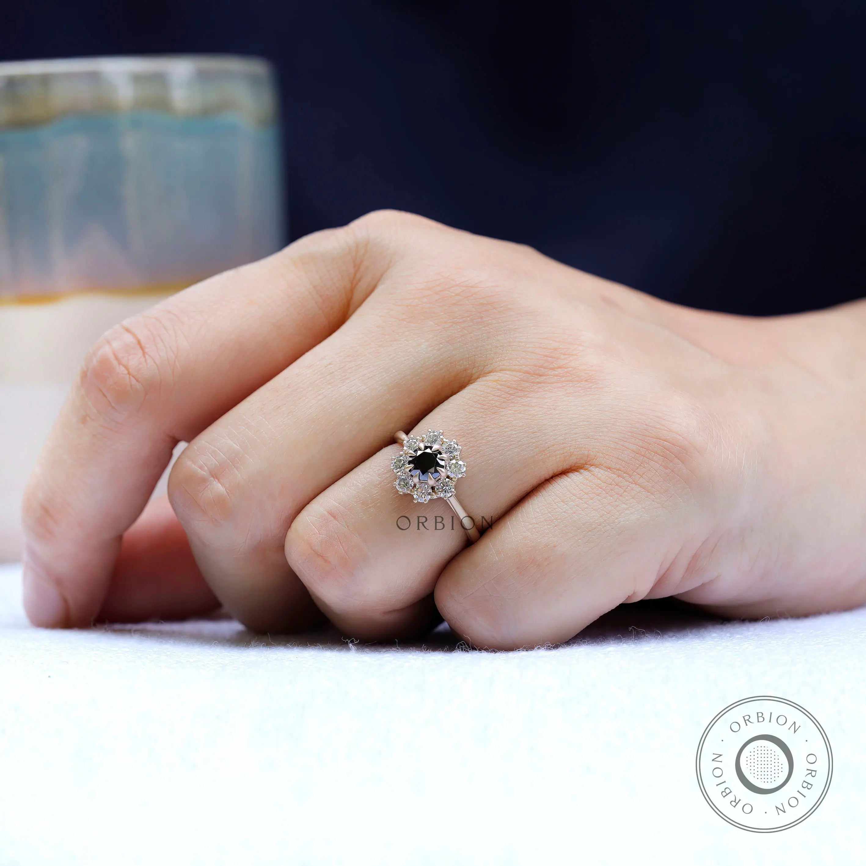 On-hand view of black moissanite halo ring
