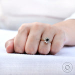 Close-up on-hand view black moissanite halo sparkle