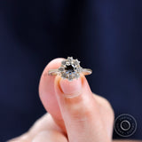 Lifestyle hand shot of black moissanite halo engagement ring