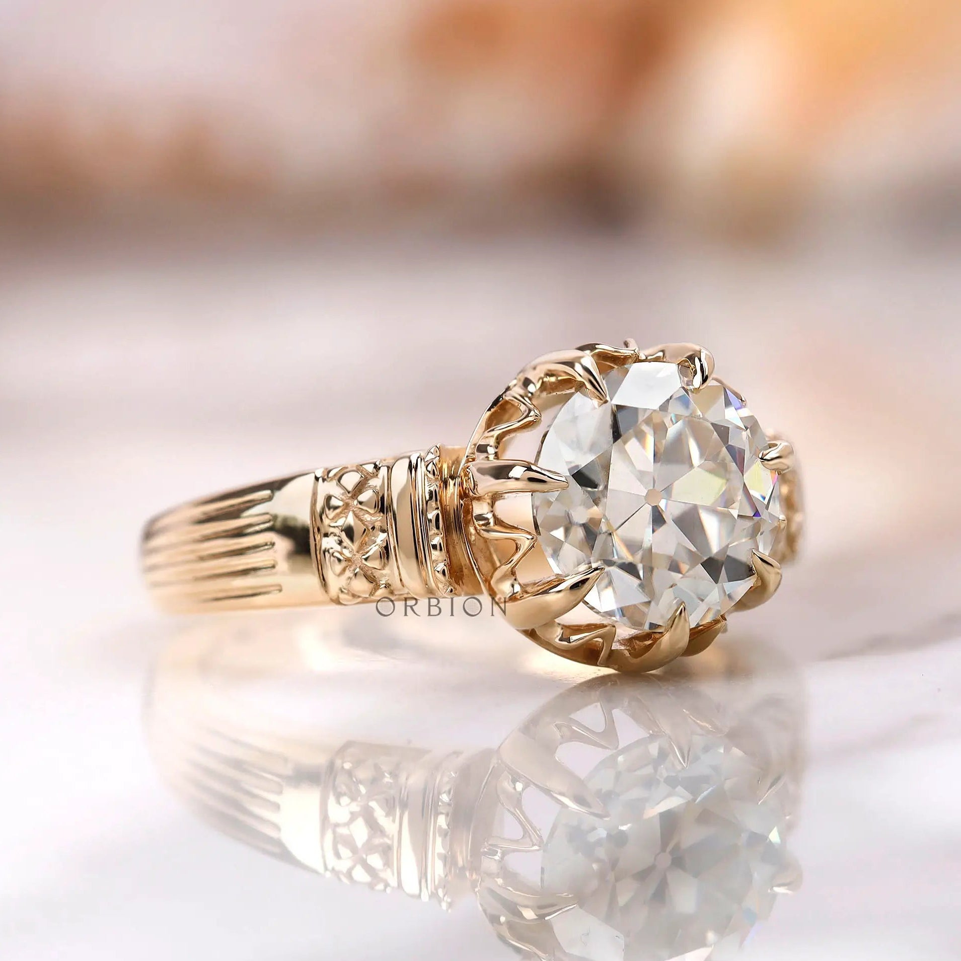 Close view of round moissanite antique style ring with crown setting