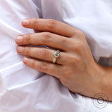 Vintage inspired round moissanite engagement ring with tapered band