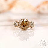Light champagne round Old European cut moissanite three stone ring in 10K yellow gold