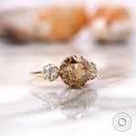 Light champagne moissanite center stone with two round side stones