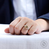 Hand worn view of champagne moissanite engagement ring