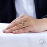 Three-stone ring with champagne center stone close up view