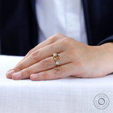 Three-stone ring with champagne center stone close up view
