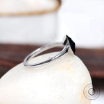 Side profile of bezel set oval moissanite solitaire ring