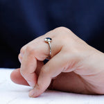 Blue oval rose cut moissanite solitaire ring worn on hand side angle