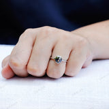 Close up of blue moissanite bezel solitaire ring on finger