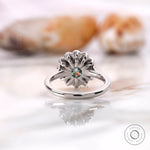 Round Old European cut center with cluster halo detail