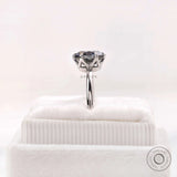 Detailed prong basket view of the grey moissanite solitaire in white gold