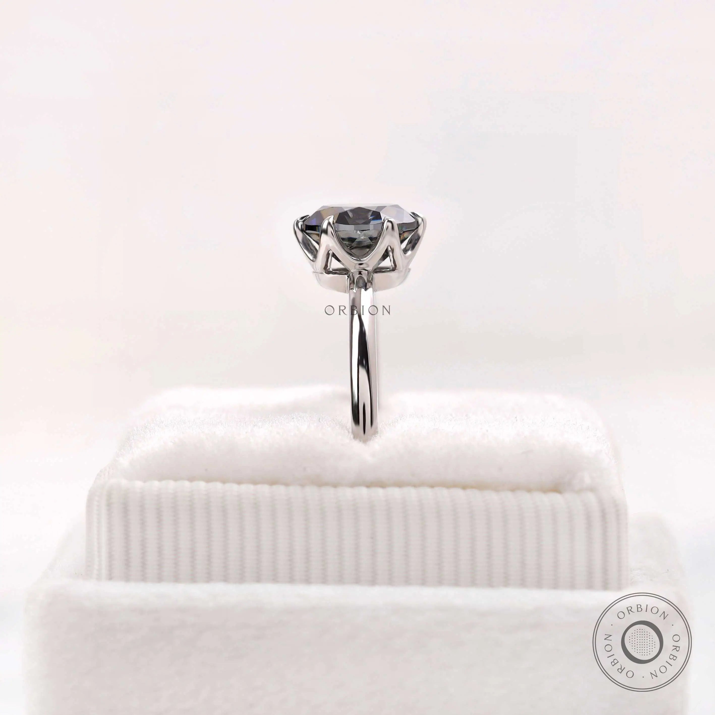 Detailed prong basket view of the grey moissanite solitaire in white gold