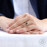 On hand view showing the scale and elegance of the grey solitaire ring