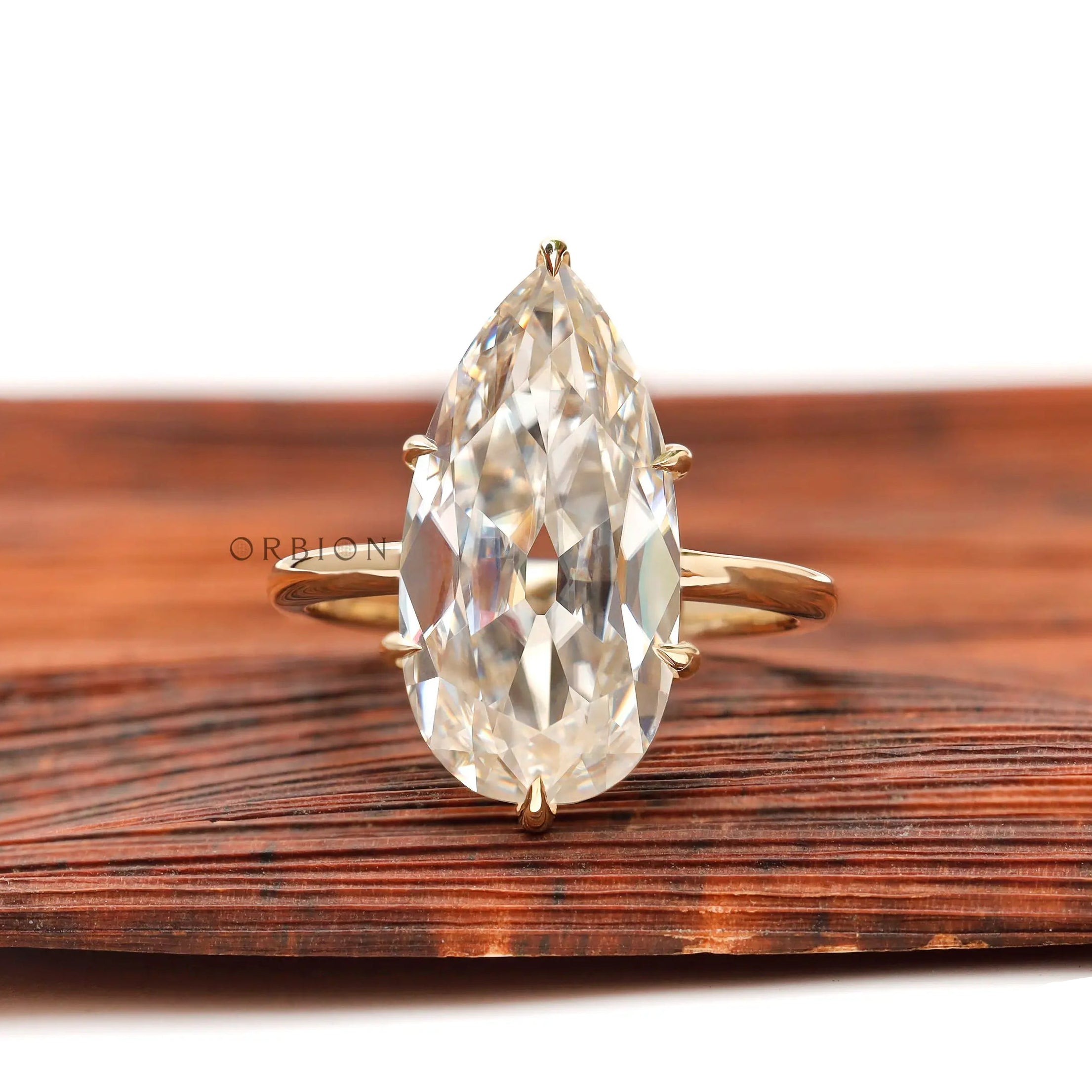 Large pear moissanite solitaire engagement ring in 14K yellow gold, front view
