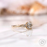 Close-up of the elegant 10K yellow gold engagement ring with a square cushion moissanite center stone and tapered band.