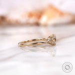 Side view of the 10K yellow gold engagement ring featuring a square cushion moissanite center stone and round brilliant-cut side stones.