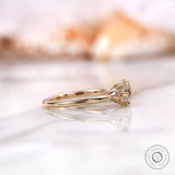 Side view of the 10K yellow gold engagement ring featuring a square cushion moissanite center stone and round brilliant-cut side stones.