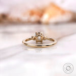 engagement ring with a square cushion center stone and round side stones.