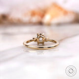 engagement ring with a square cushion center stone and round side stones.
