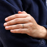 Hand model showcasing the 10K yellow gold moissanite engagement ring with a square cushion center stone.