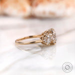 Antique style three stone moissanite ring in yellow gold side angle