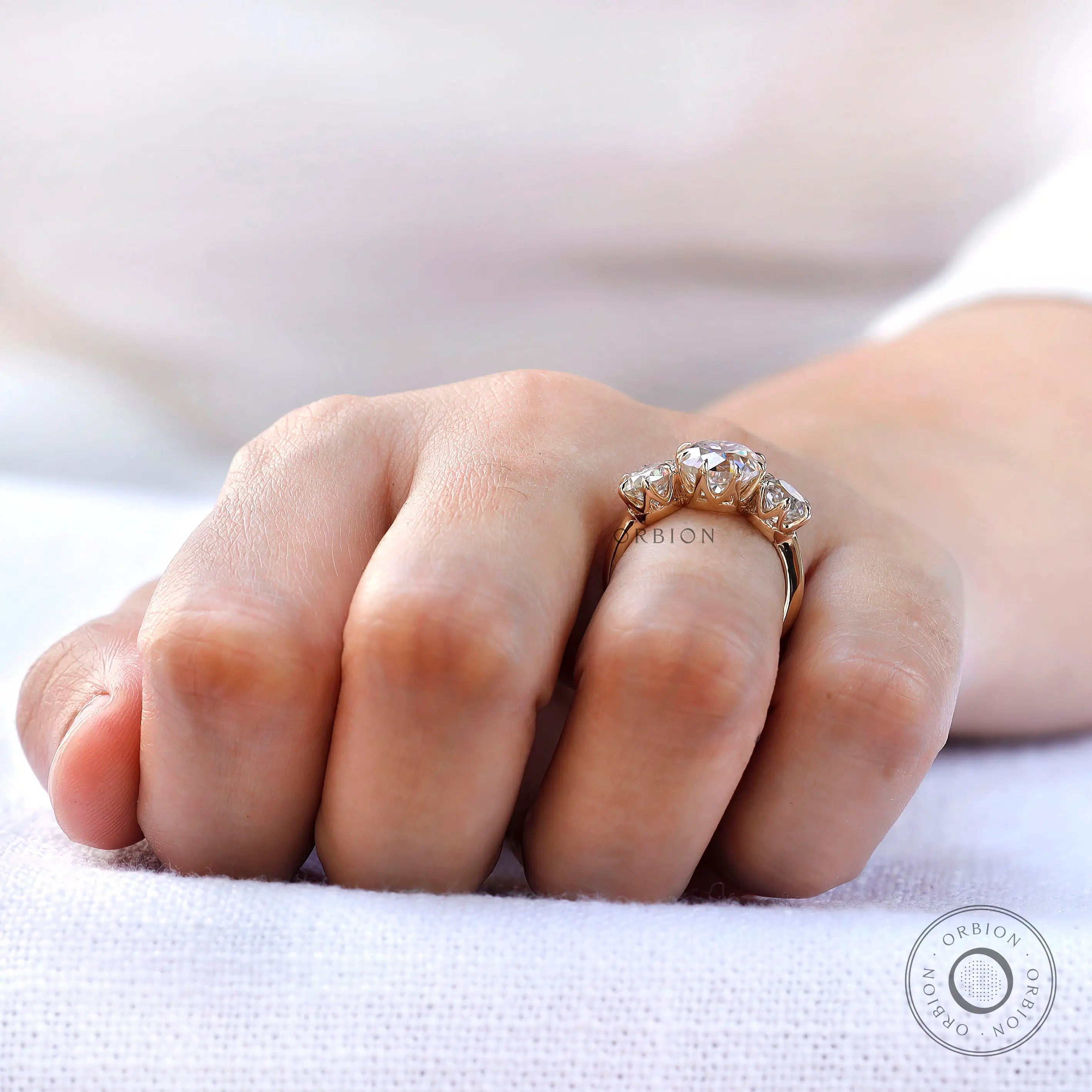 Three stone moissanite engagement ring prong setting detail