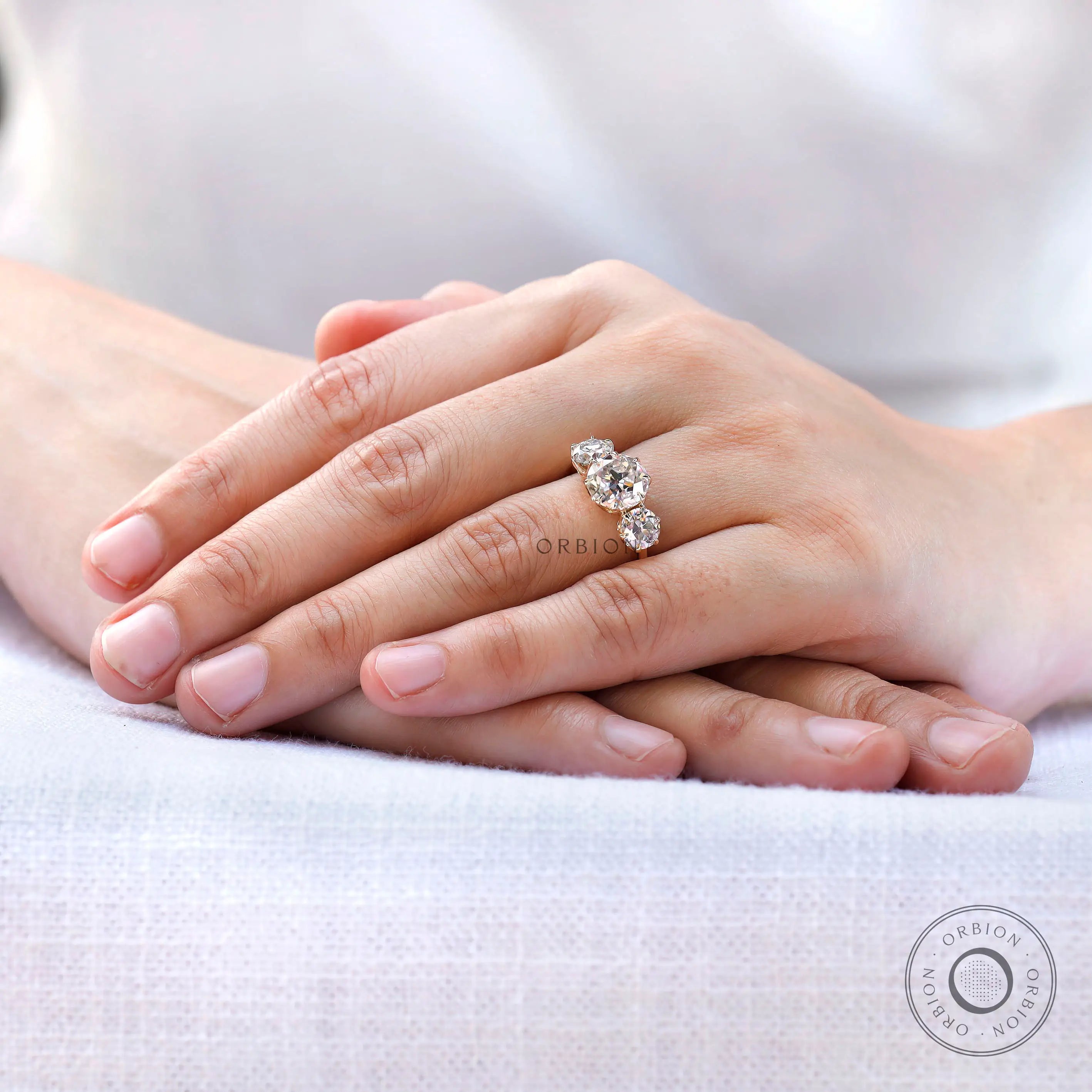 Vintage inspired round moissanite ring worn on hand