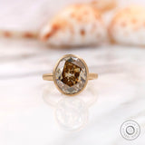 Bezel set oval champagne moissanite ring shown front view