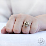 Bezel set oval champagne ring worn on hand