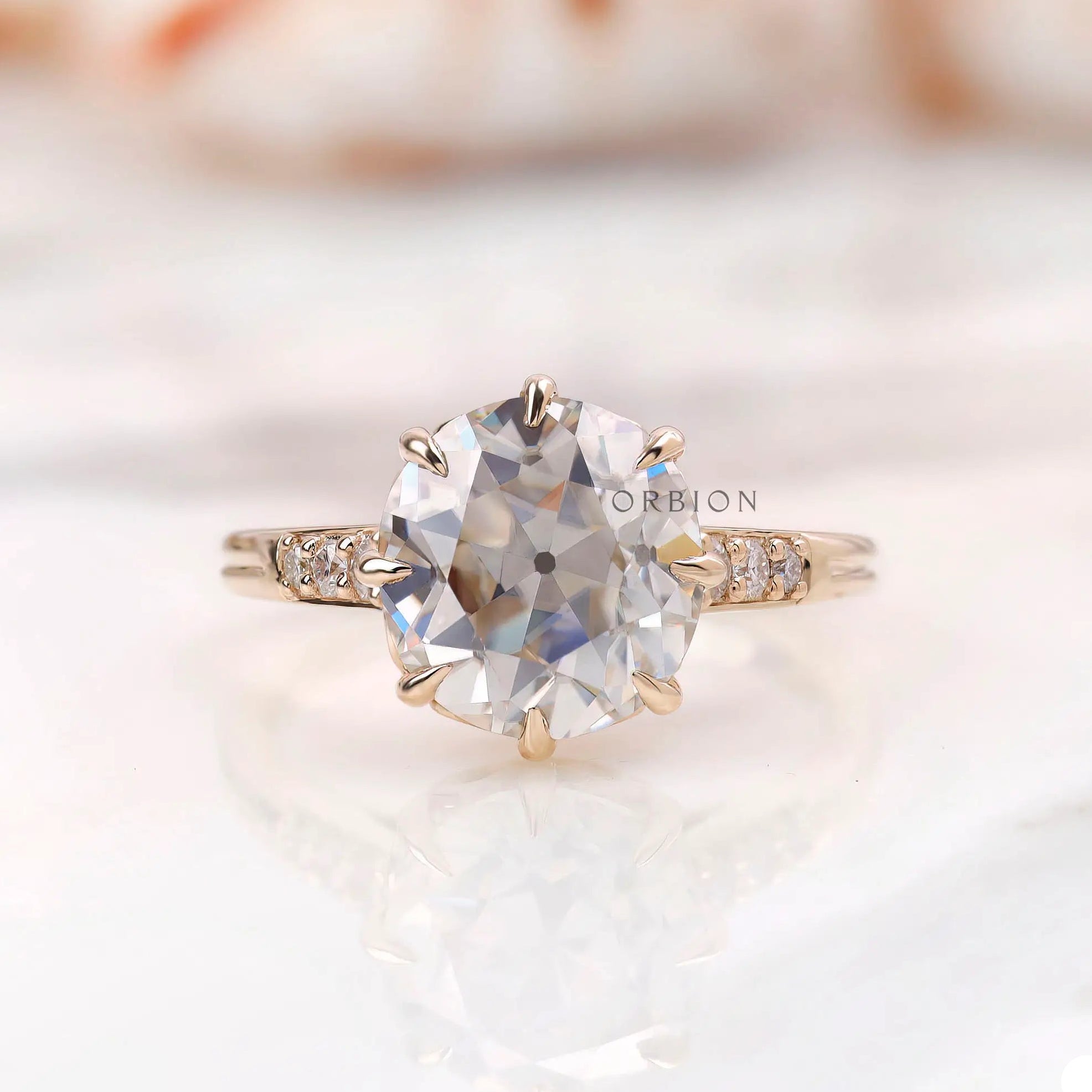Front view showing round asymmetric Old European Cut moissanite