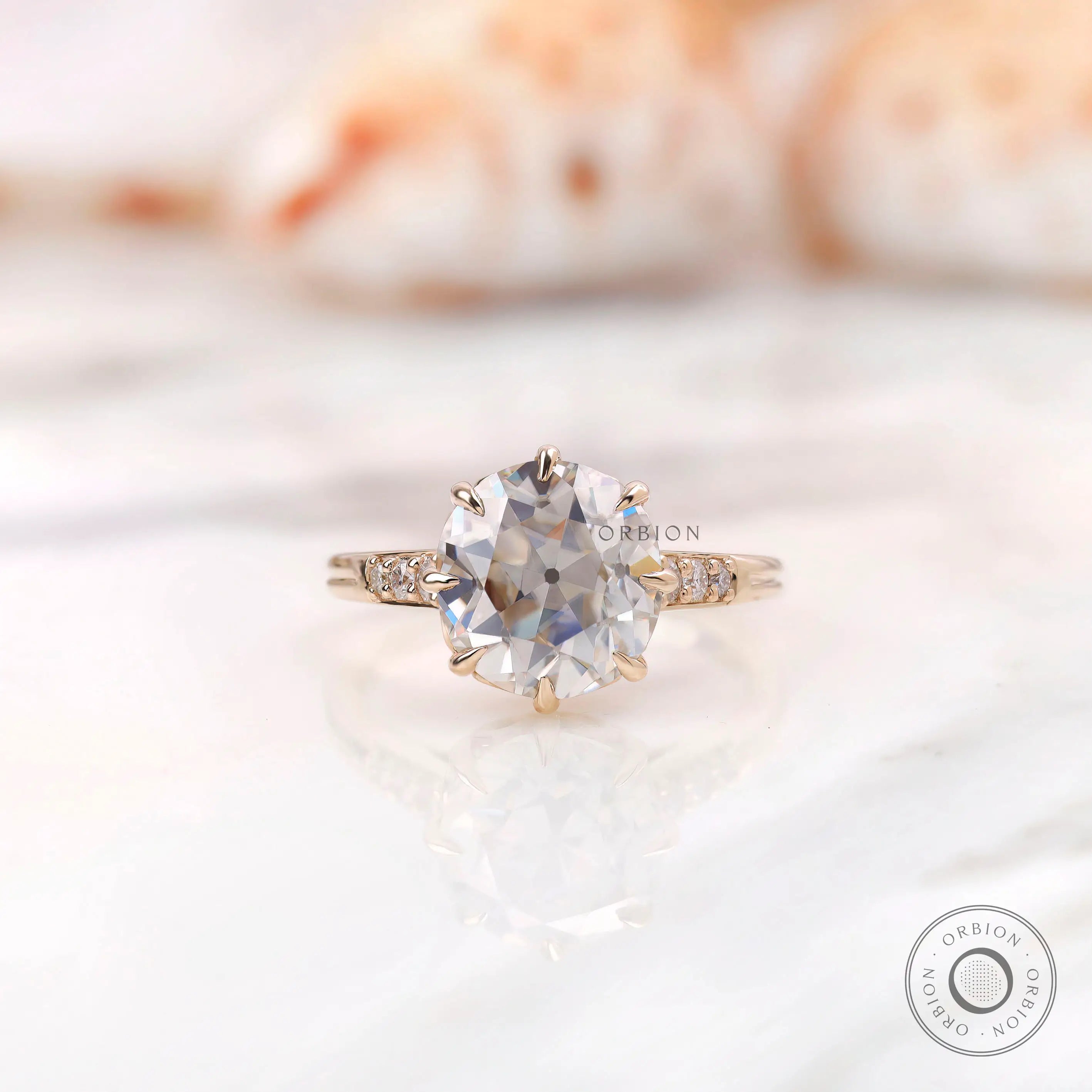 Front view showing round asymmetric Old European Cut moissanite