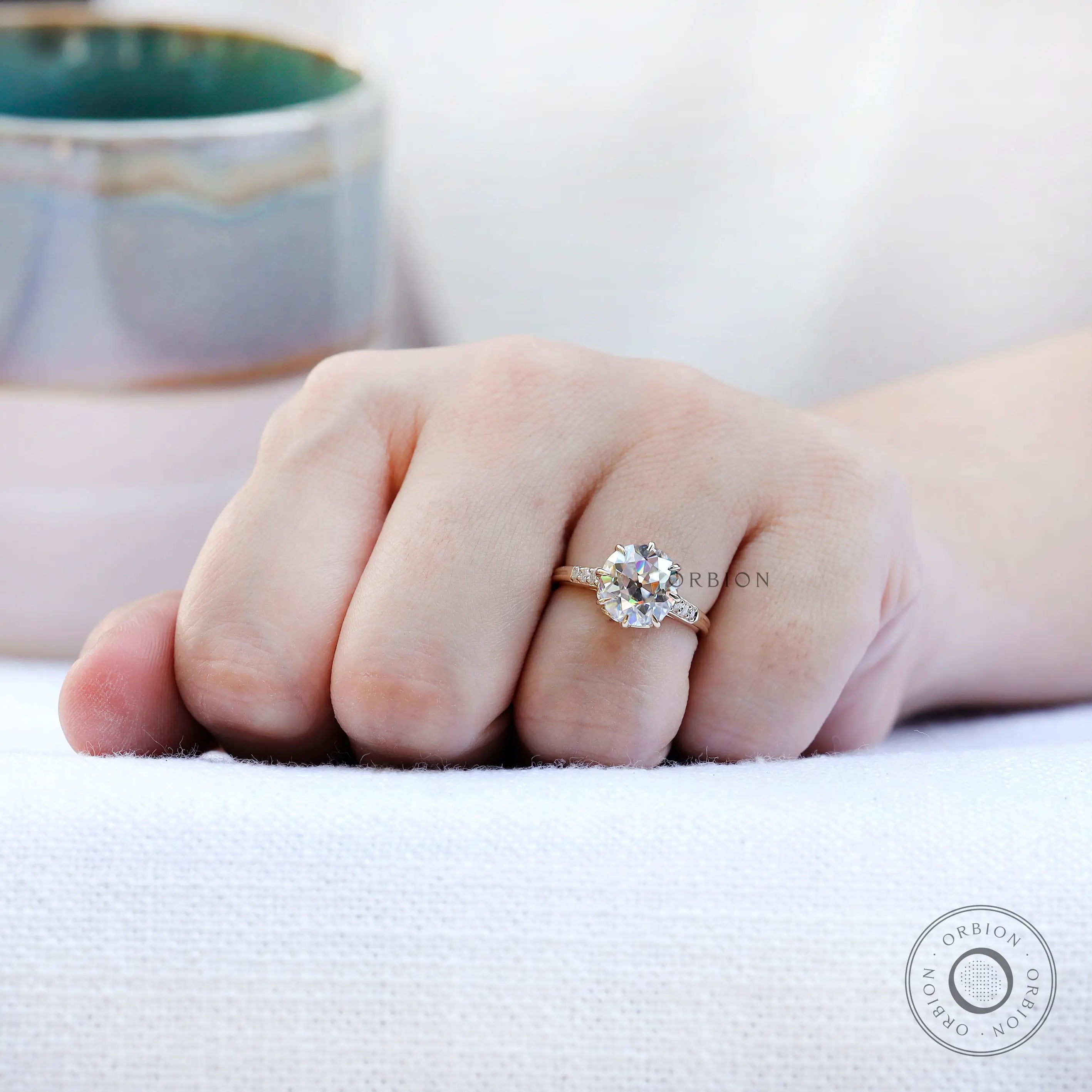 Hand shot displaying ring proportions and center stone size