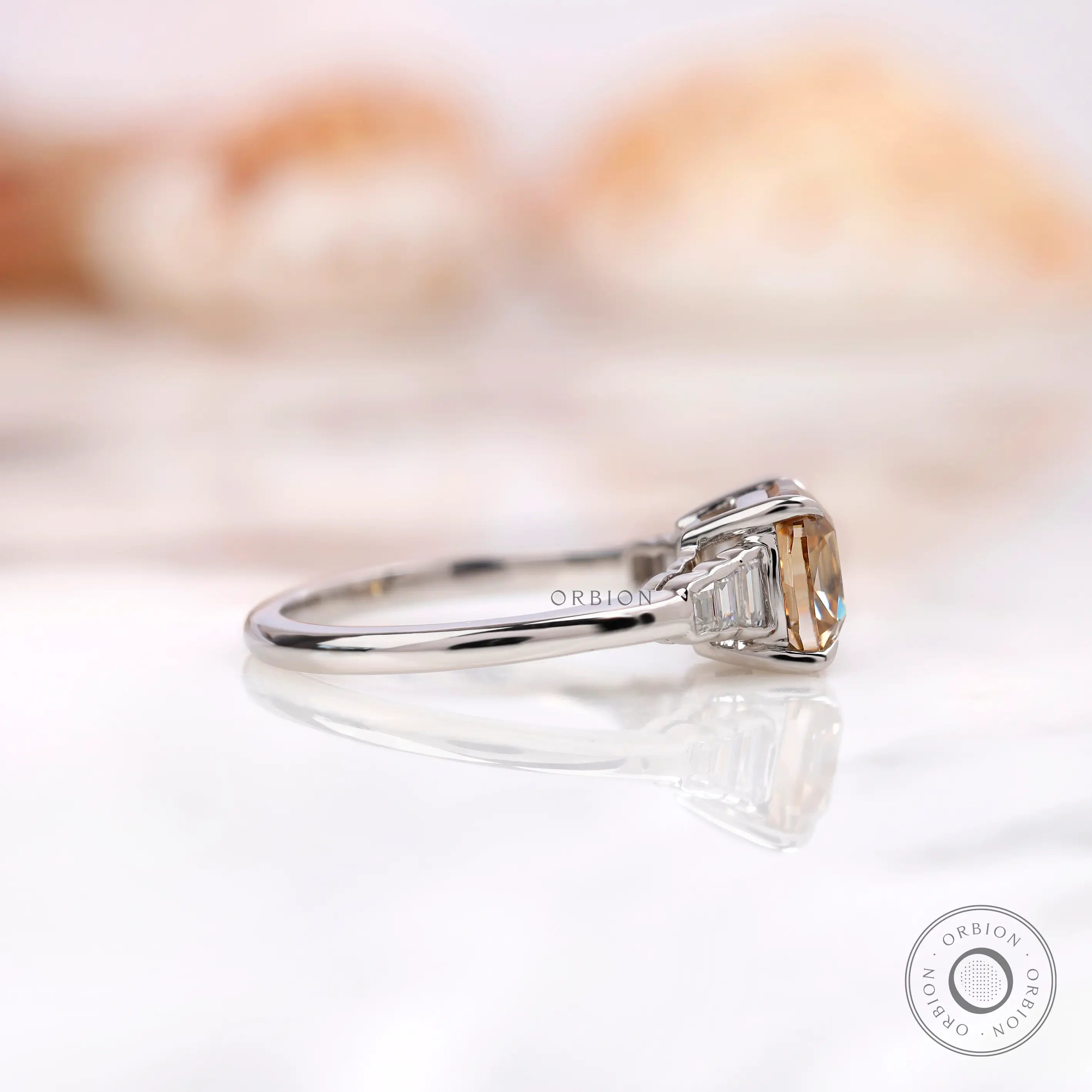 Side profile of a champagne cushion moissanite engagement ring.