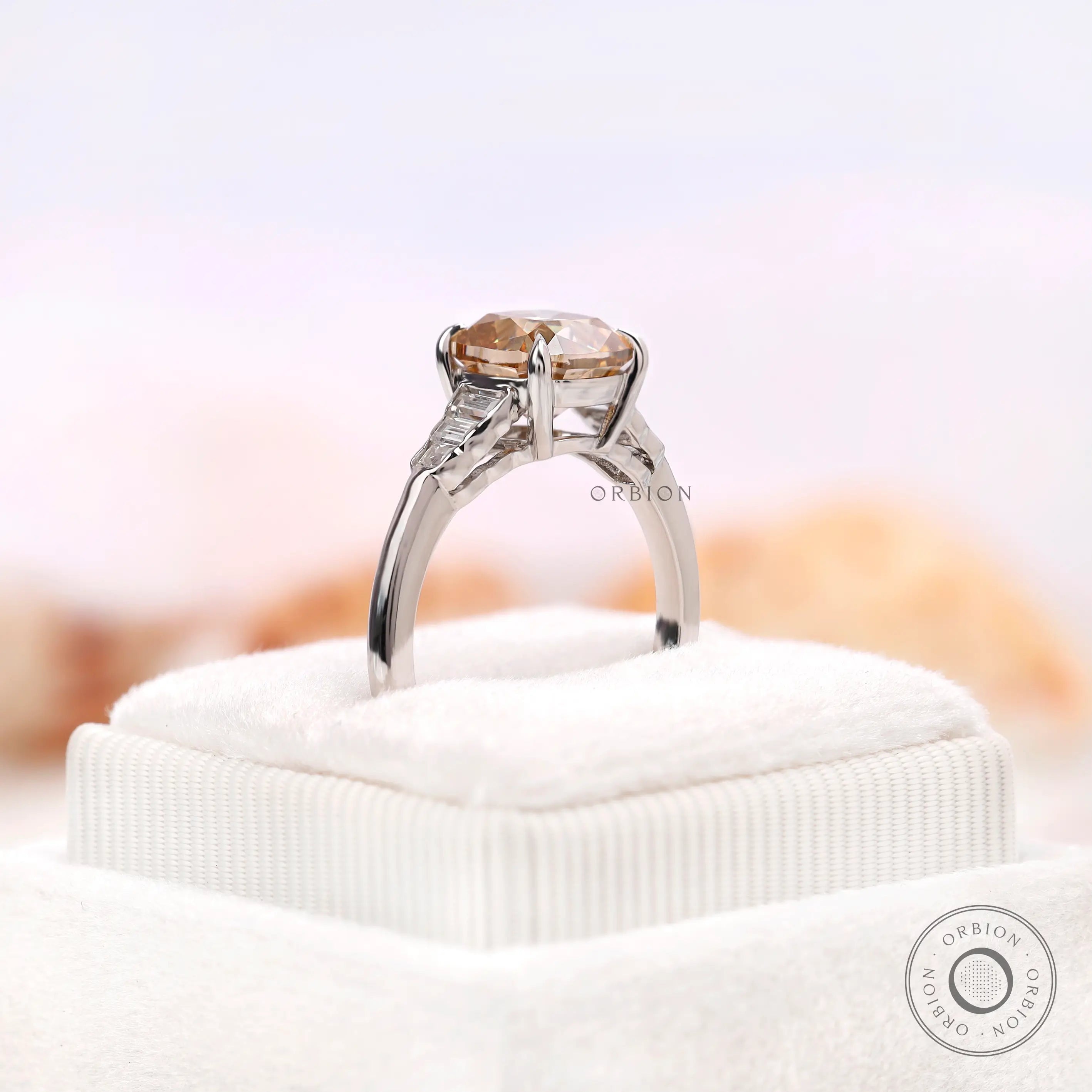 View of the bottom of a champagne moissanite ring showing the side stones