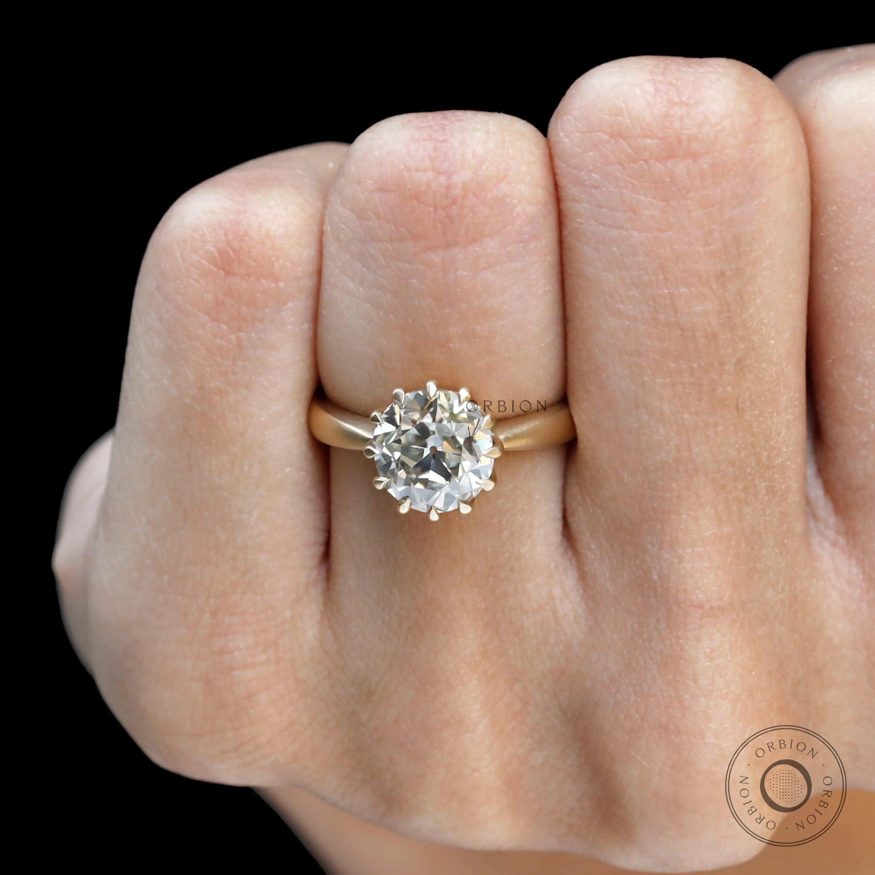 Yellow gold moissanite ring close-up sparkle detail