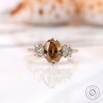 Three stone oval champagne moissanite ring shown from front