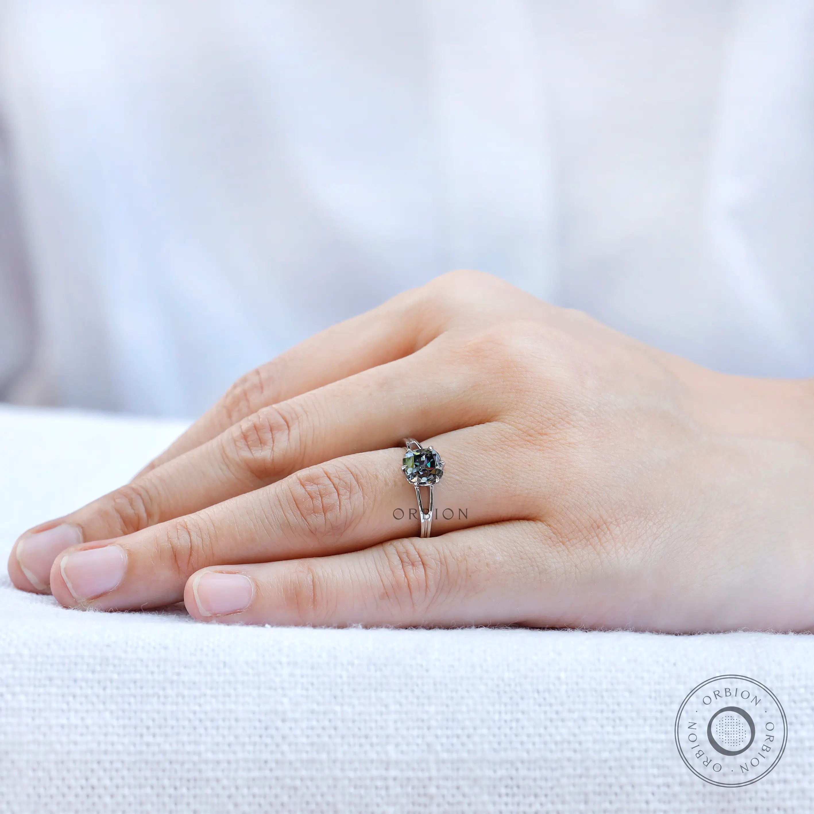 Elongated cushion old mine cut moissanite solitaire ring on hand