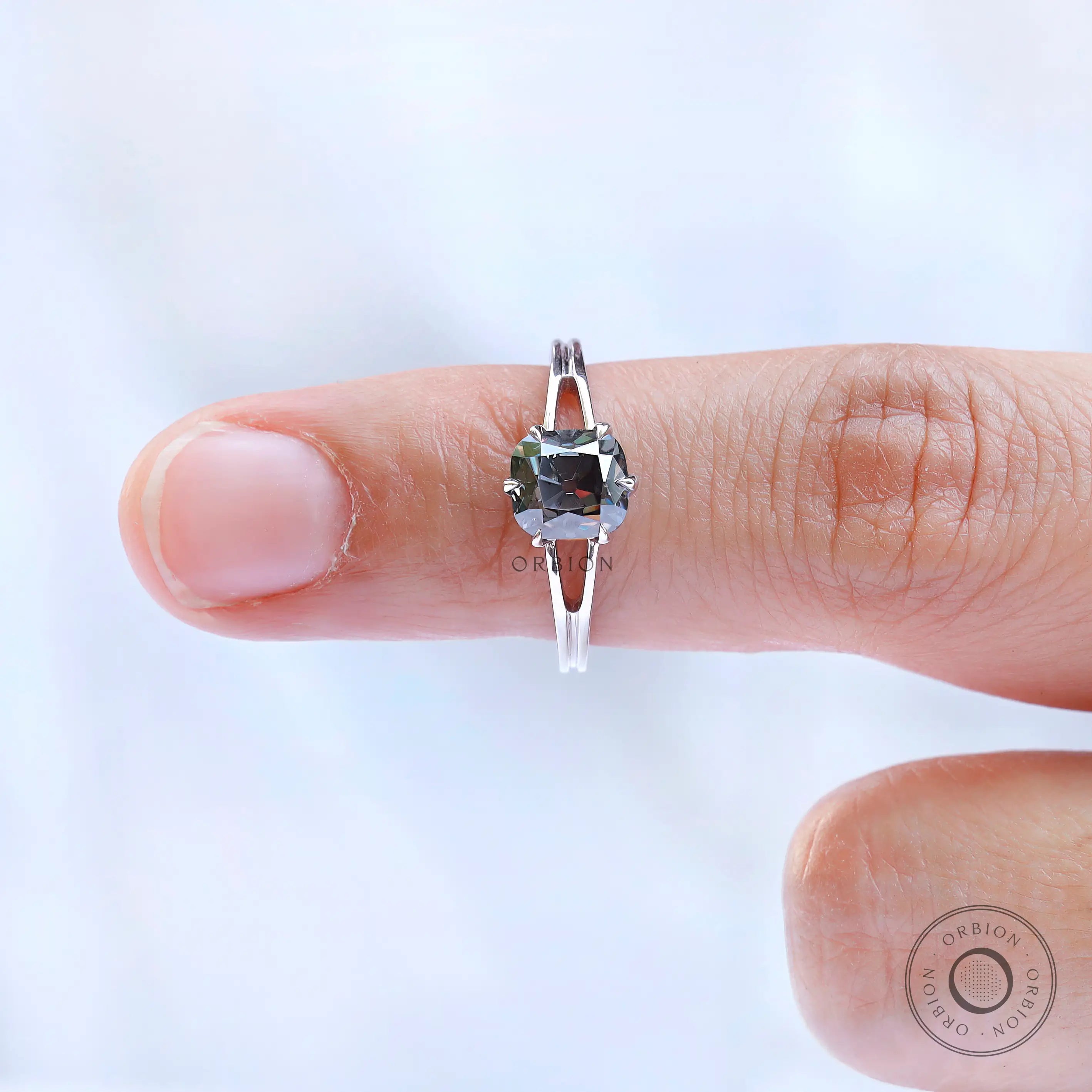 Cushion cut grey moissanite solitaire ring detailed prong view